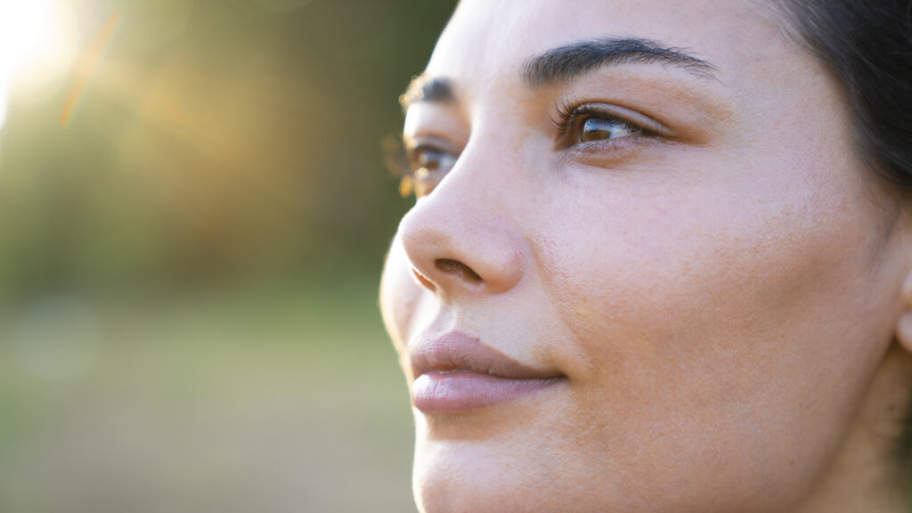 Close up of a woman, not needing to wear glasses anymore after getting LASIK surgery for improved vision.