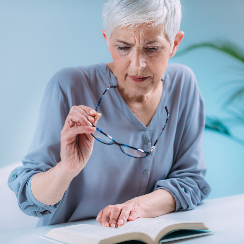 Older woman taking off her glasses and struggling with vision loss as a result of onset glaucoma symptoms. Older woman taking off her glasses and struggling with vision loss as a result of onset glaucoma symptoms.